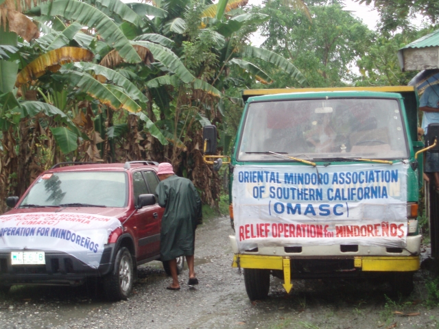 OMASCs lead car and one of the 2 Naujan dump trucks carrying the food packages for distribution.