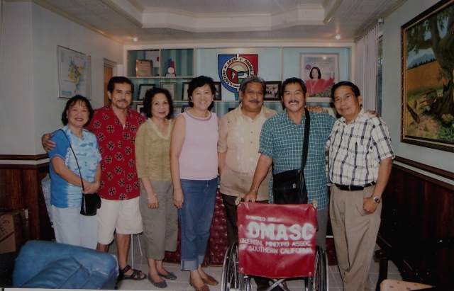 Mayor Winefredo Hernandez of Pinamalayan receiving wheelchairs from Omasc officers:Left to right - Dolly Morente, Bobby Morente, Alina Roldan, Elsie Amansec, the Mayor, Boy Moriente & Dr. Fred Villao. 